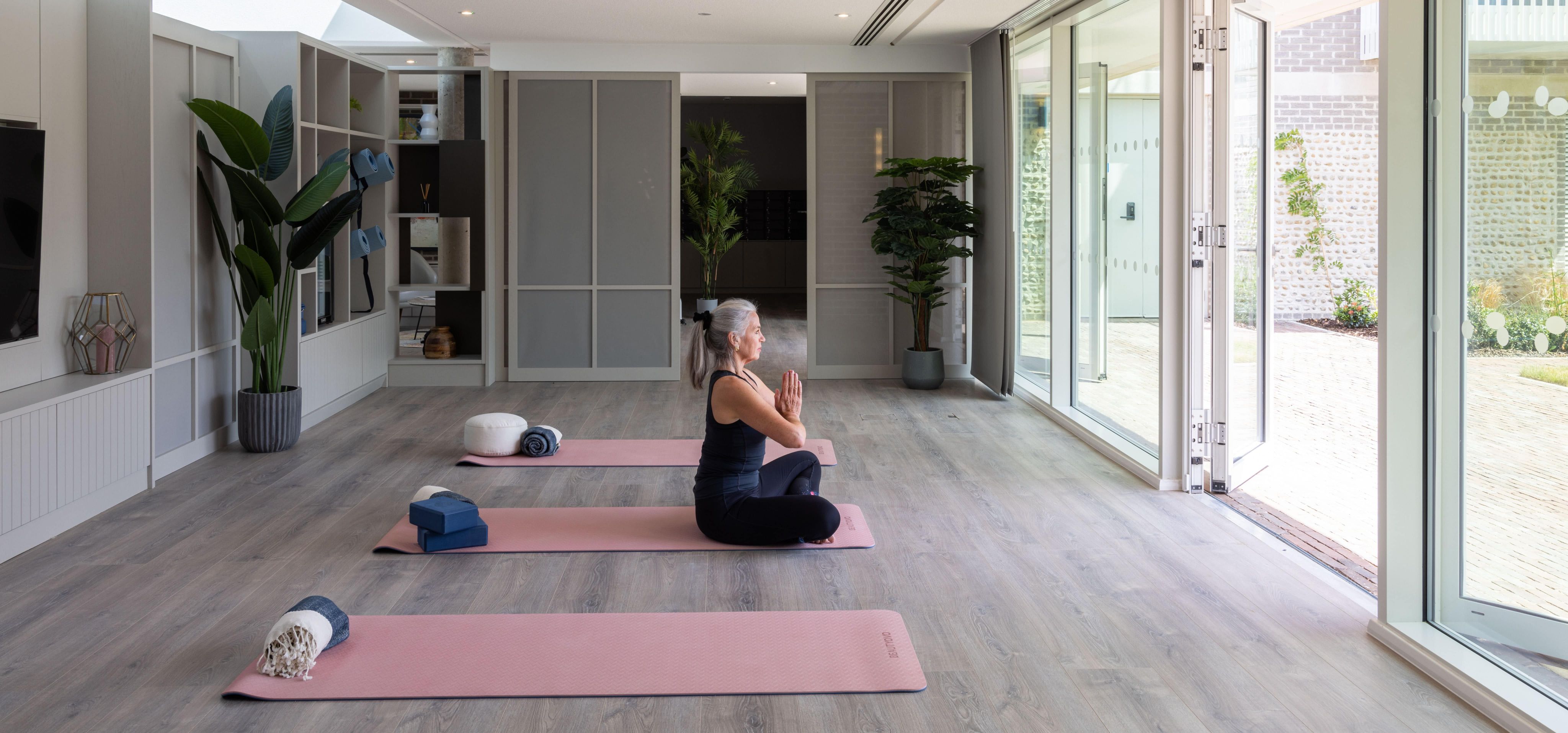 Woman Meditating in yoga studio